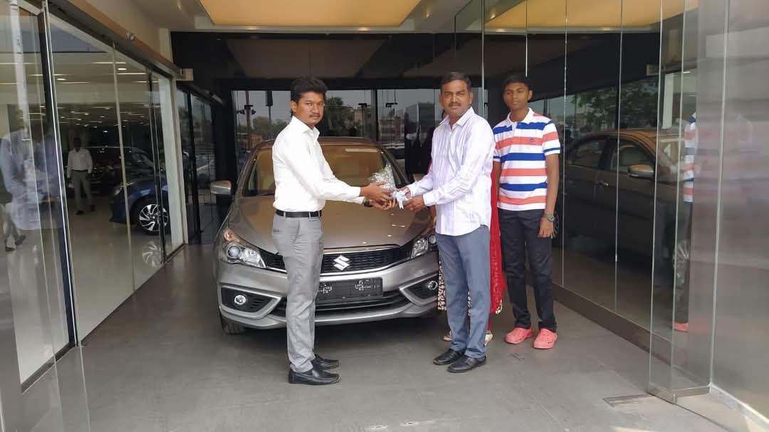 Satisfied customers getting car loan clearance and delivery in showroom