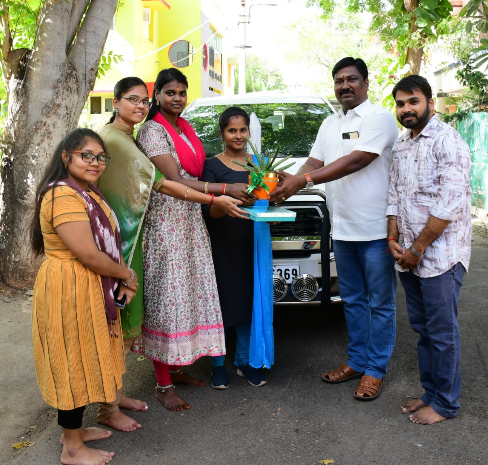 Group photo with new car delivered through Sakthi Associates.